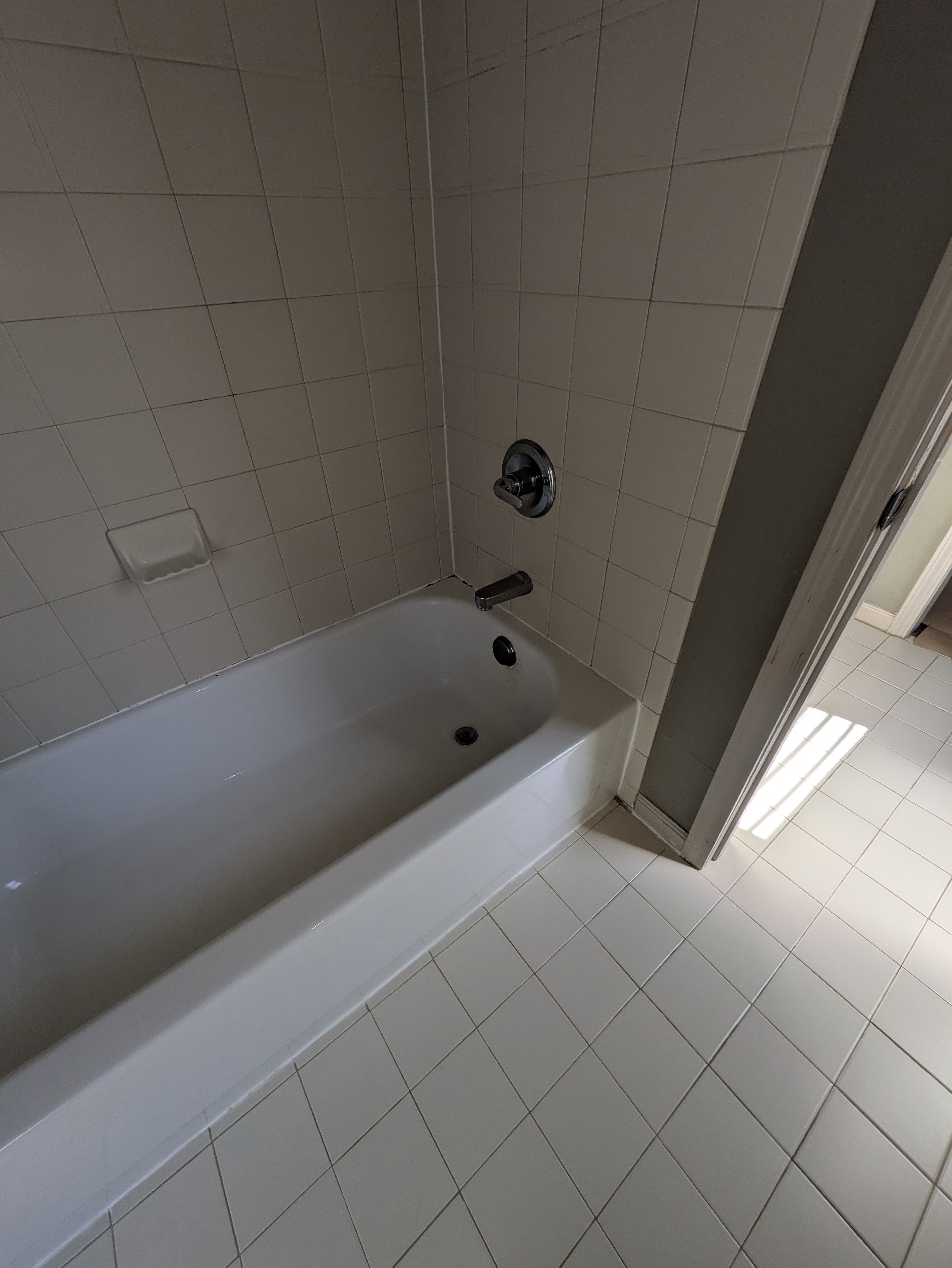 New white bathtub installed in a renovated Normaltown bathroom